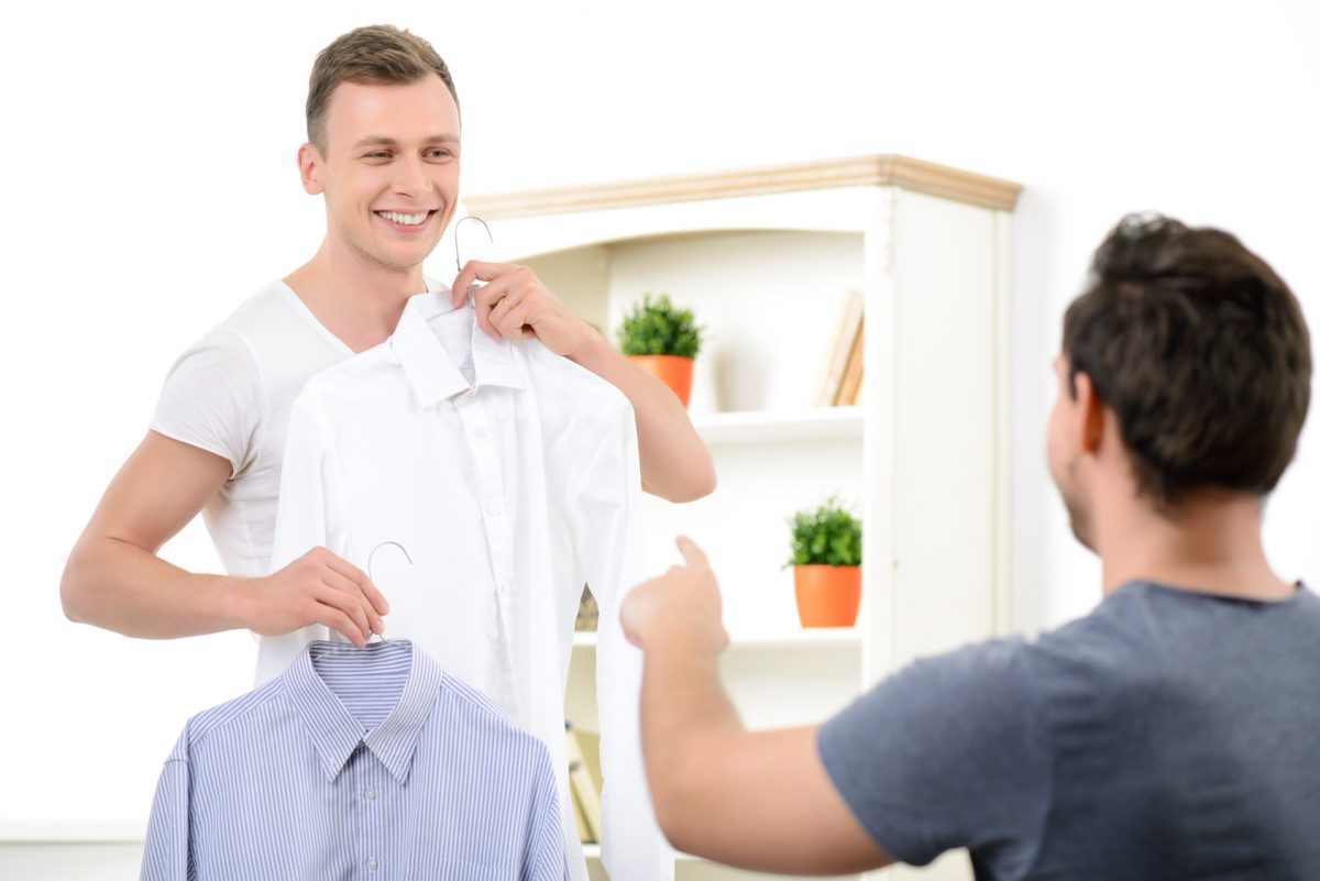 man choosing work clothes with male partner for new job after experiencing same sex harassment handled by a Chicago sexual harassment lawyer