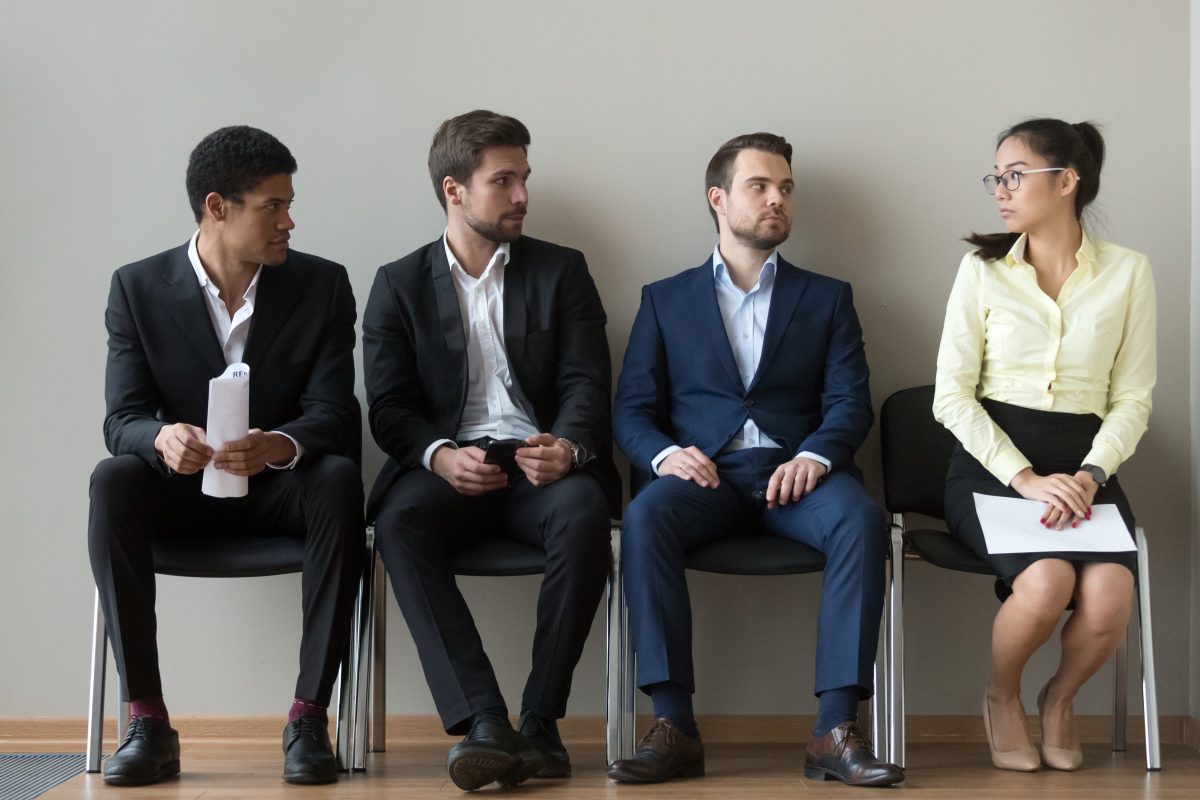 Group of three men and one woman waiting to interview, if you have experienced sex discrimination, consult with our Chicago Workplace Discrimination Attorney.