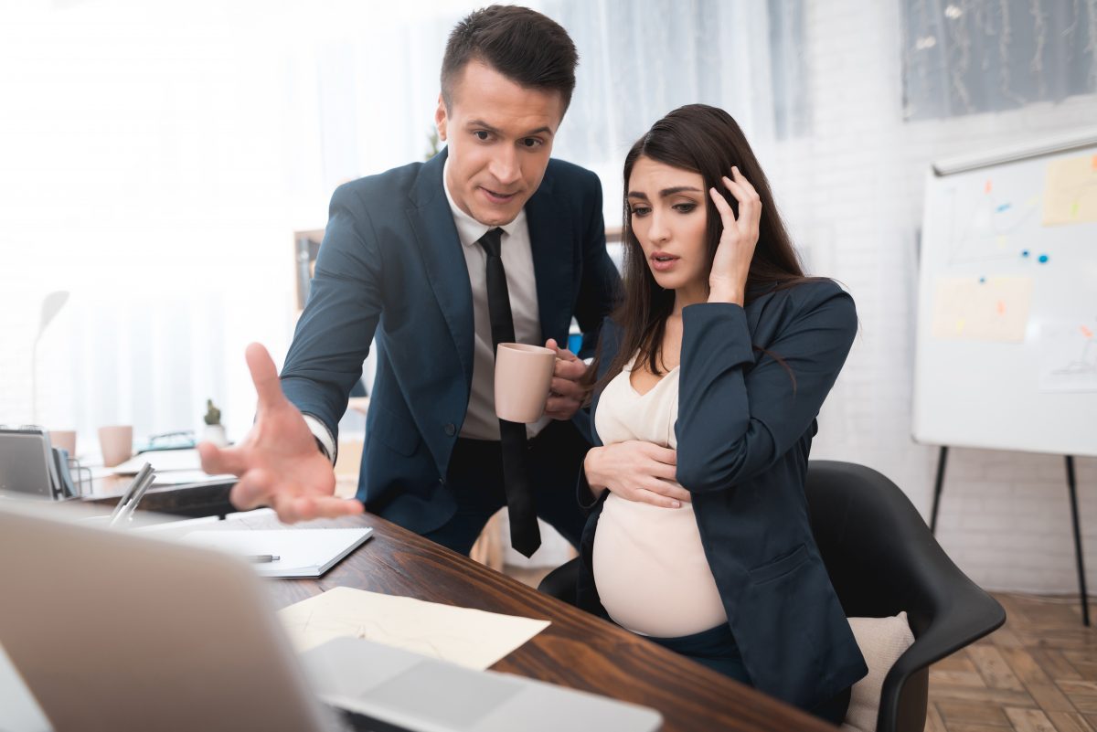 A pregnant woman at work getting yelled at by boss, know your rights by talking to Pregnancy Discrimination Lawyer Evanston.