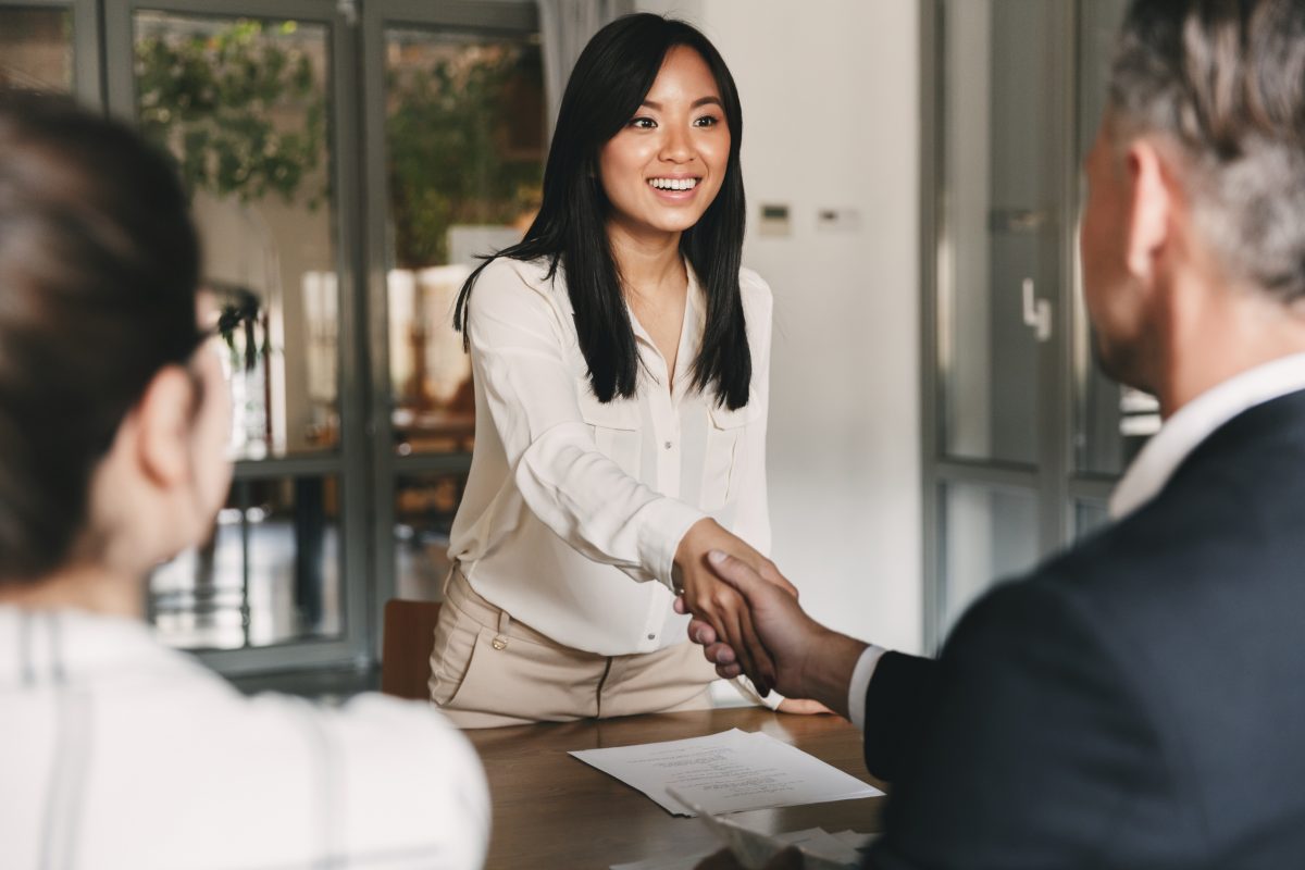 A woman shaking hands with a potential employer after a job interview representing how an Illinois discrimination attorney can assist you if you have experienced discrimination in the hiring process.