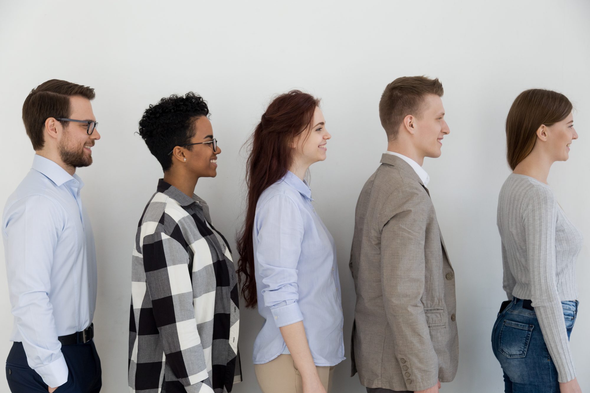 Five people standing in line representing possible hires to company turn to Workplace Discrimination Attorney in Chicago for help with case.